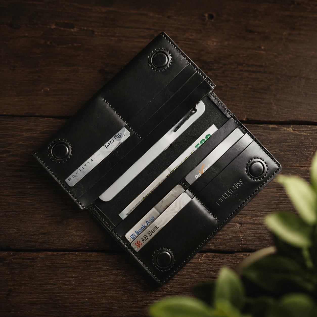 2.	Black leather long wallet with zipper compartment and phone storage