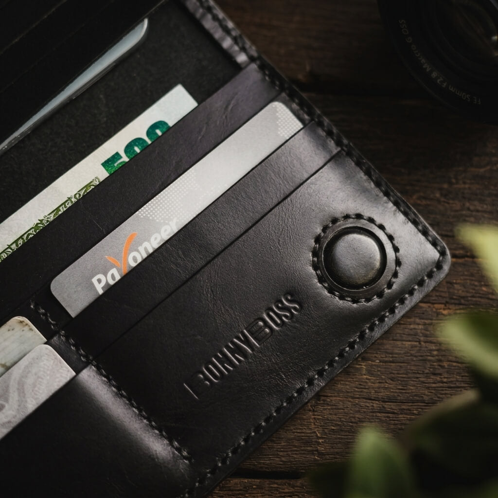 5.	Black leather long wallet with snap button closure and Bonny Boss branding
